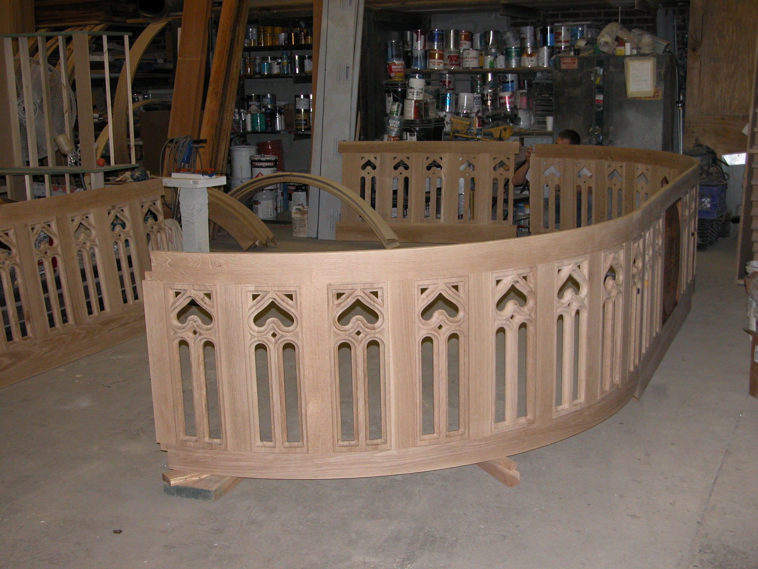 In-progress photo of the wooden choir stage railing at Fordham University, showcasing the construction of a new wooden railing system for the stage area
