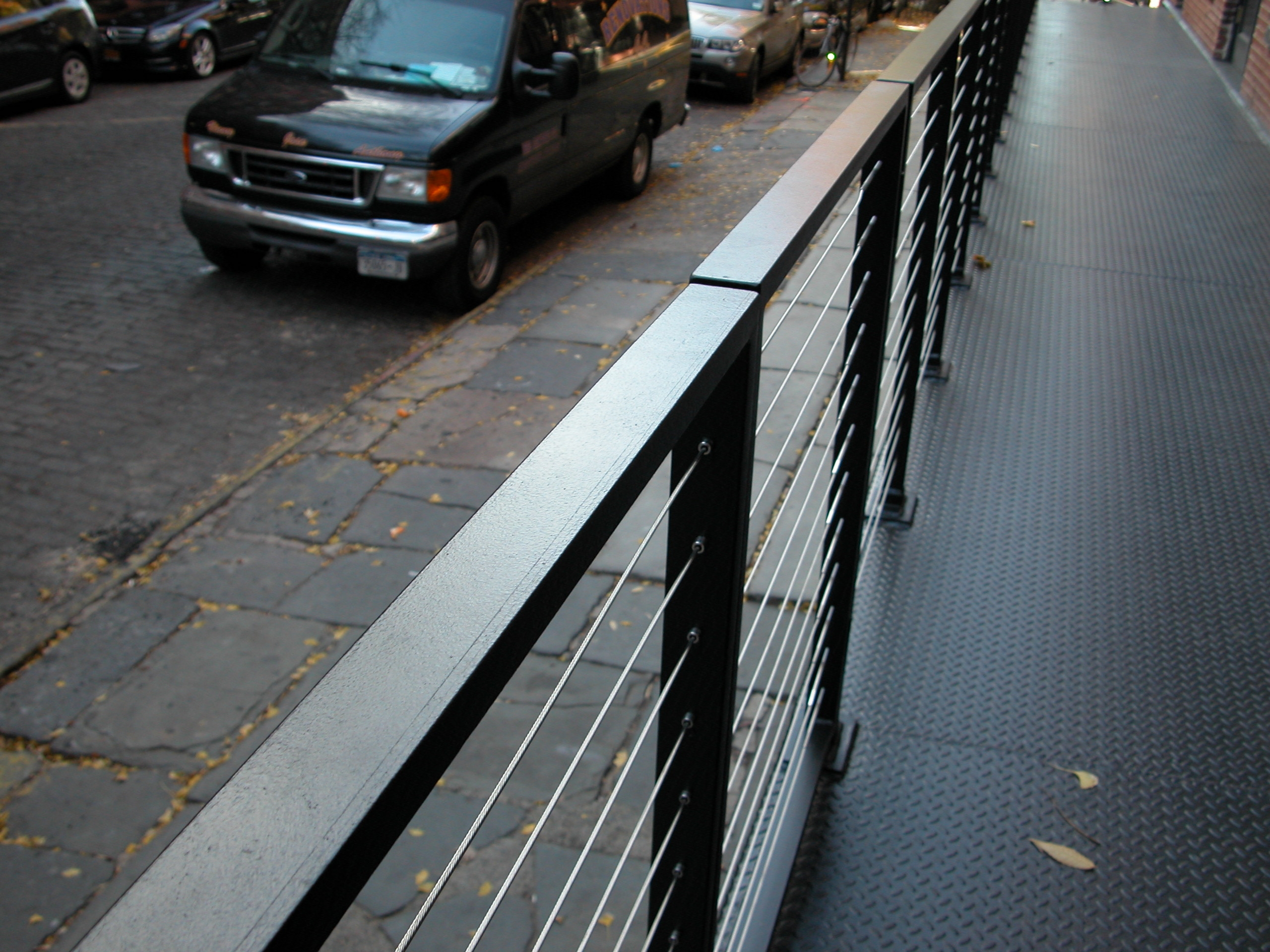 Cable railings with diamond plate base at 201 West 13 Street