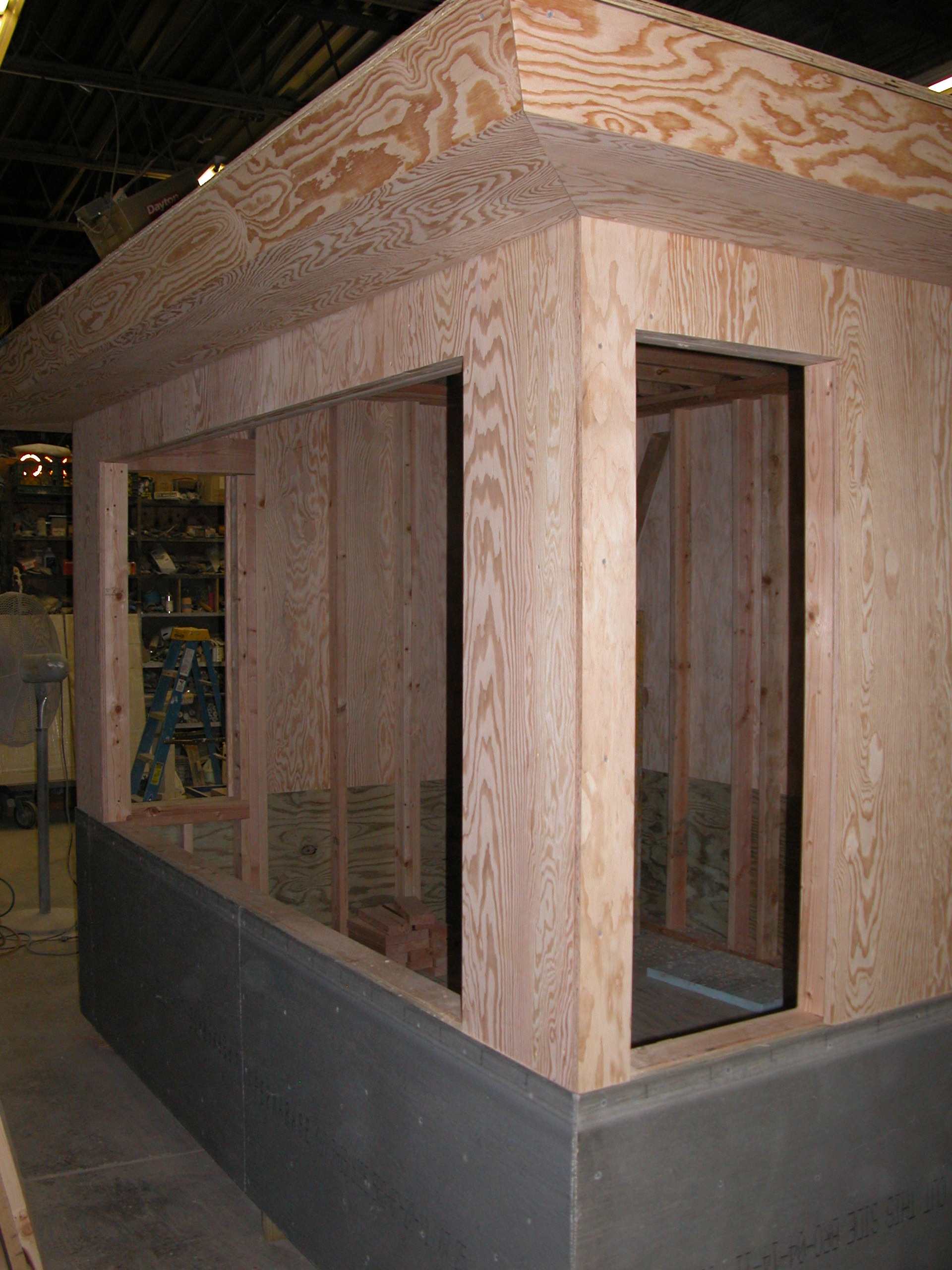 In-progress photo of the wooden security booth at Fordham University, showing the construction of a new wooden structure for security purposes.