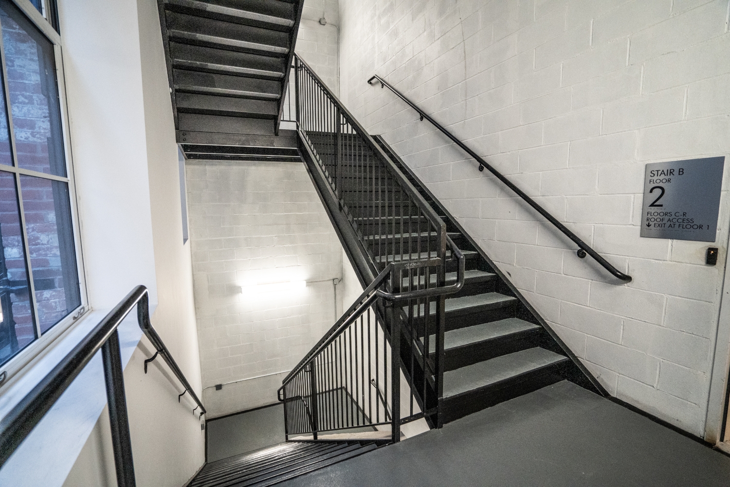 New CMU stair-shaft with metal stairs and railings, showcasing ironworks and metal craftsmanship