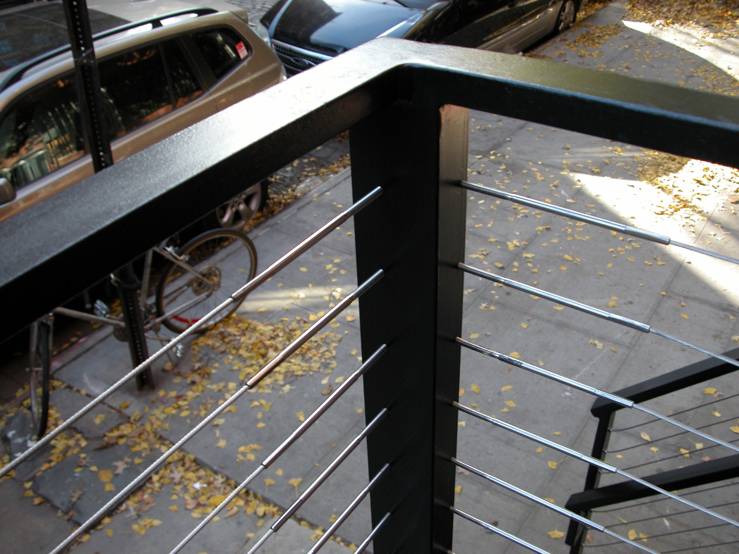 Close-up of cable railing with diamond plate base at 201 West 13 Street