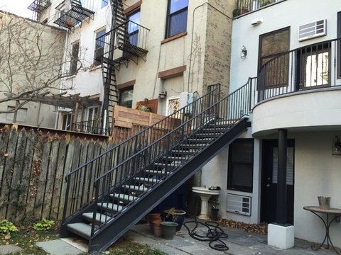 Metal stairs with stone steps and metal railings