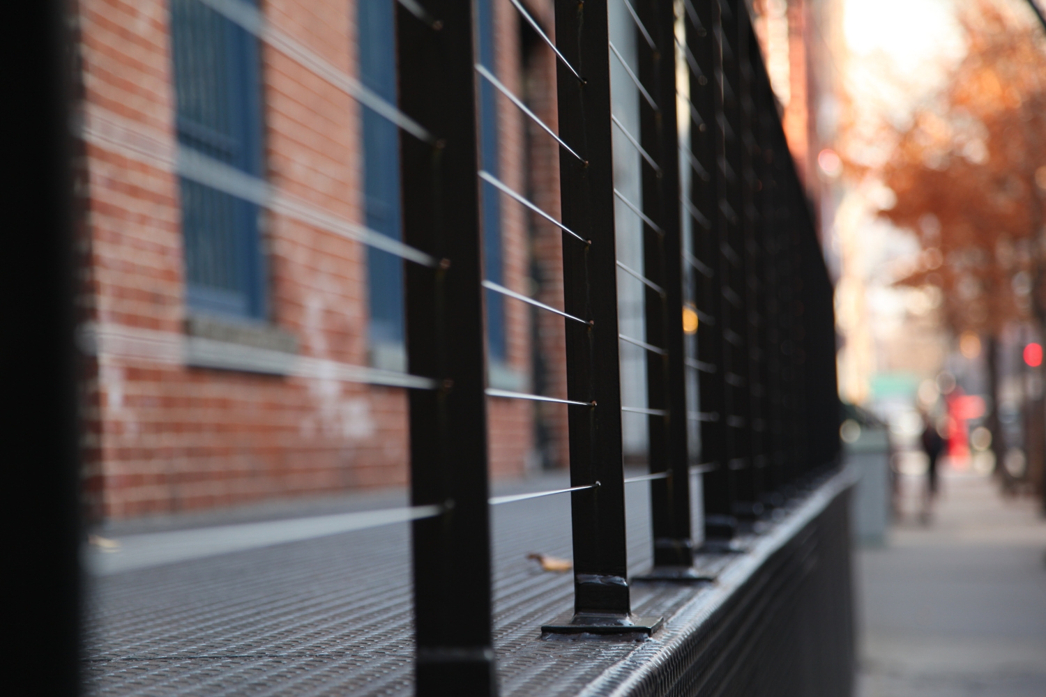 Detailed view of cable railing with diamond plate base at 201 West 13 Street