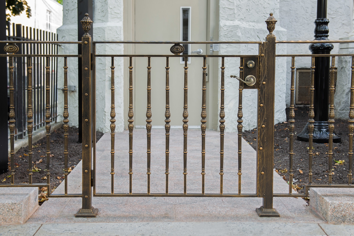Ornate metal railings with a gate at Holy Cross Church