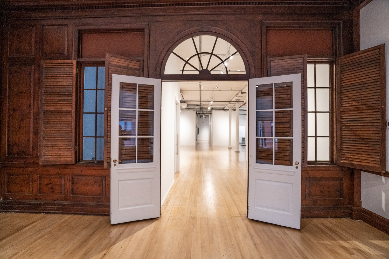 Interior view of 80 White Street in Manhattan, showcasing Jepol Construction's interior finishing services, including the restoration of historic wood elements, wood floor refinishing, wooden glass door replacement, steel column restoration, and painting. The image also shows new gypsum partitions, an example of Jepol's expertise in interior renovations and restorations.