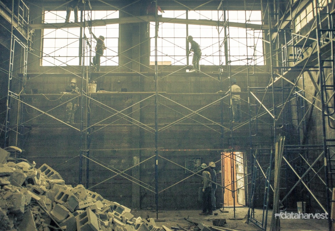 Photo showing Jepol construction workers assembling scaffolding on inside of the building