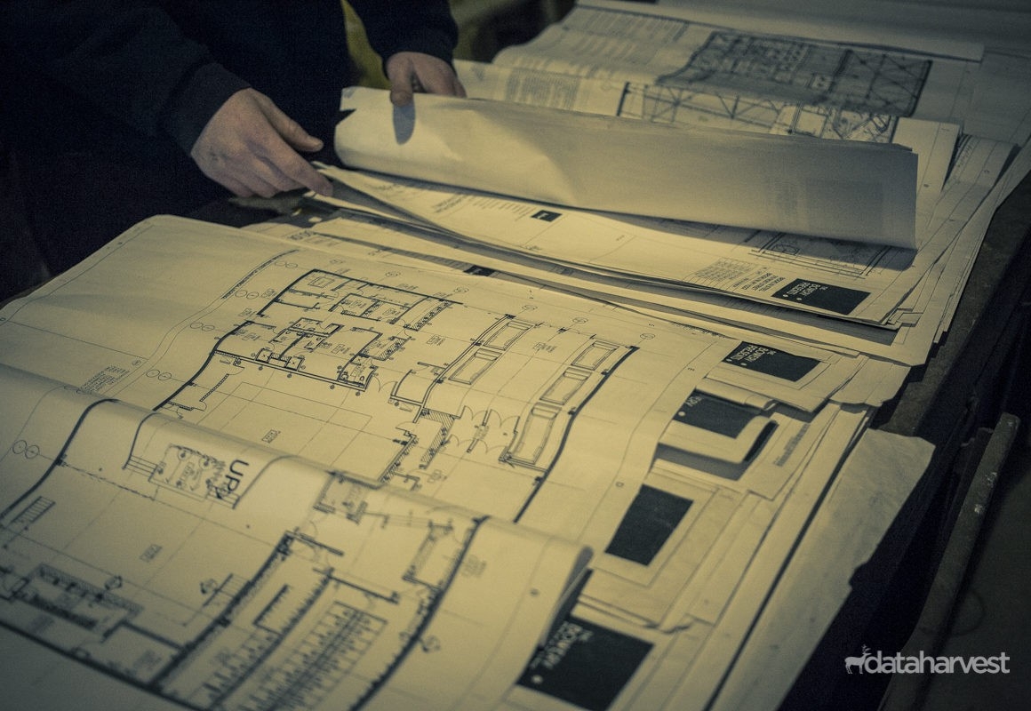 Close up shot taken of the blueprints being examined by contractor