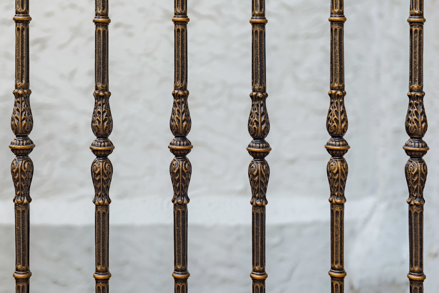 Metal railings with intricate painted details at Holy Cross Church in Maspeth, Queens