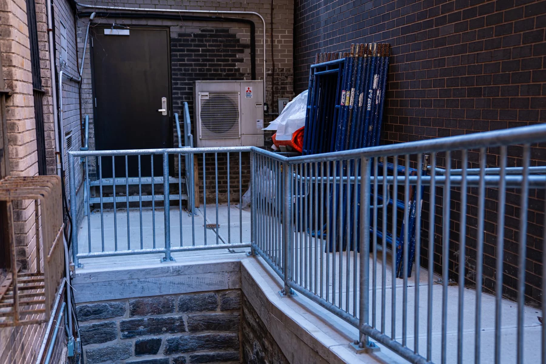 Completed access landing, stairs, and metal railings at 1088 Park Avenue