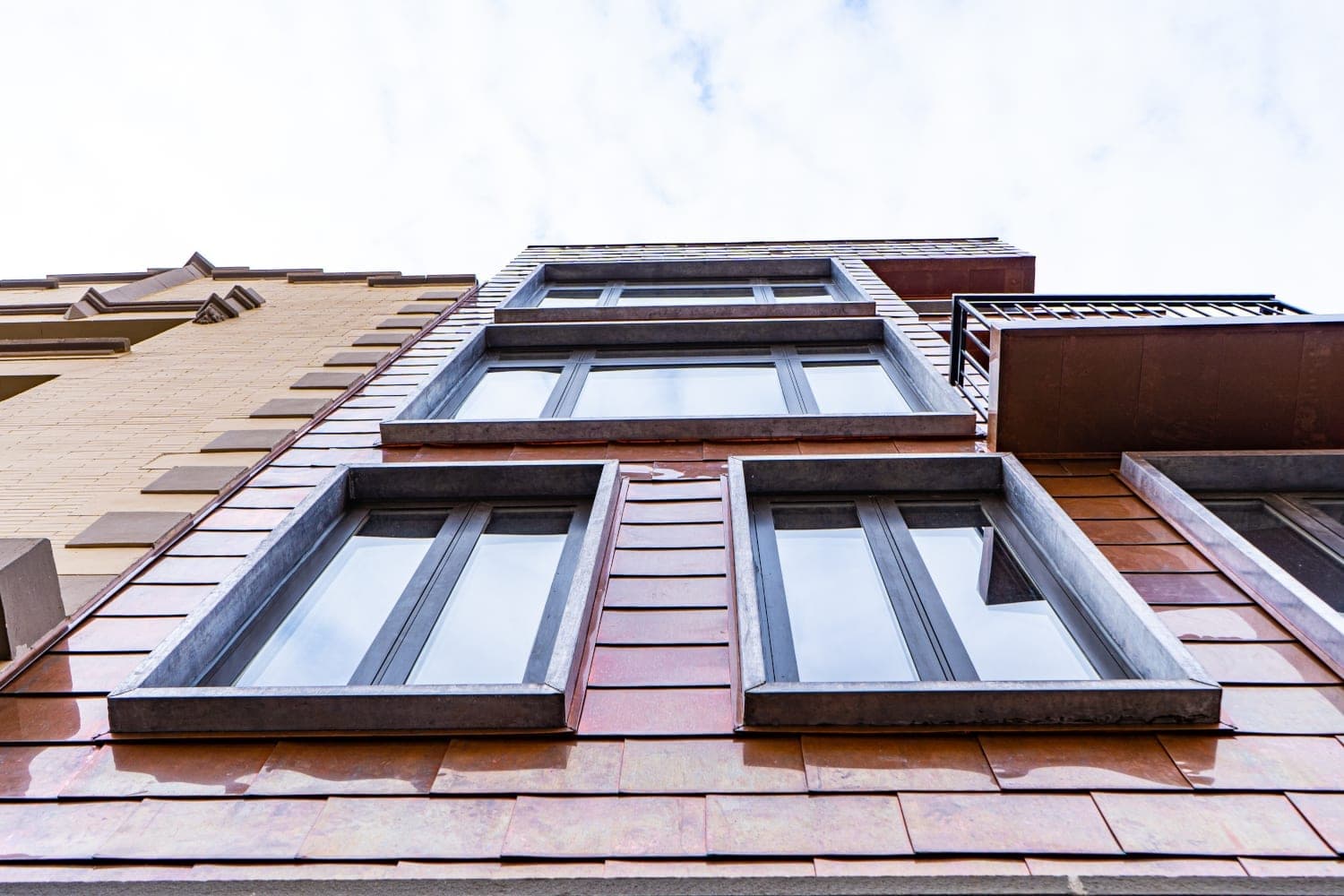 Copper cladding and metal-trimmed window openings