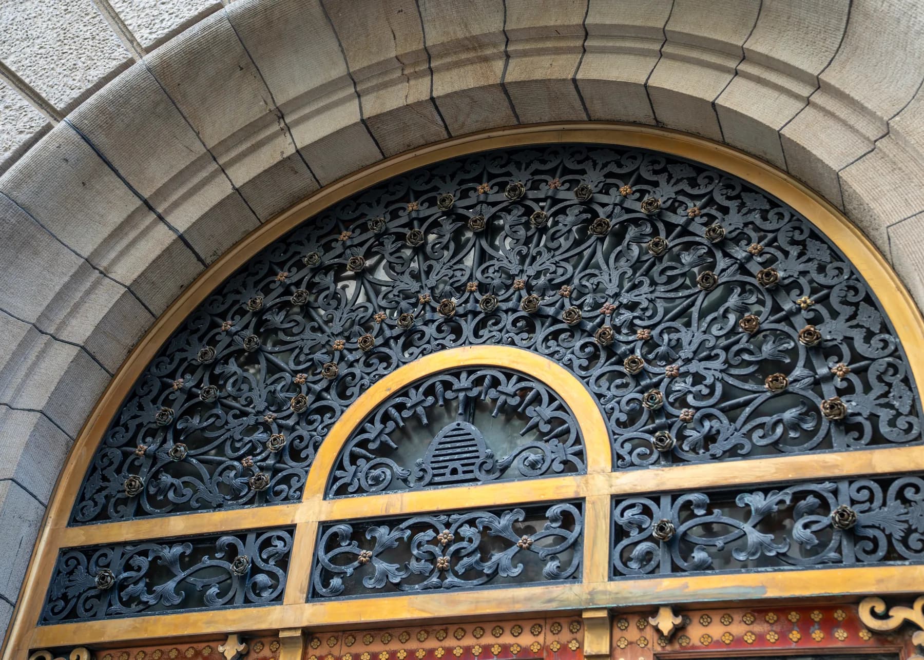 Intricate historic grille filling the arched entrance opening