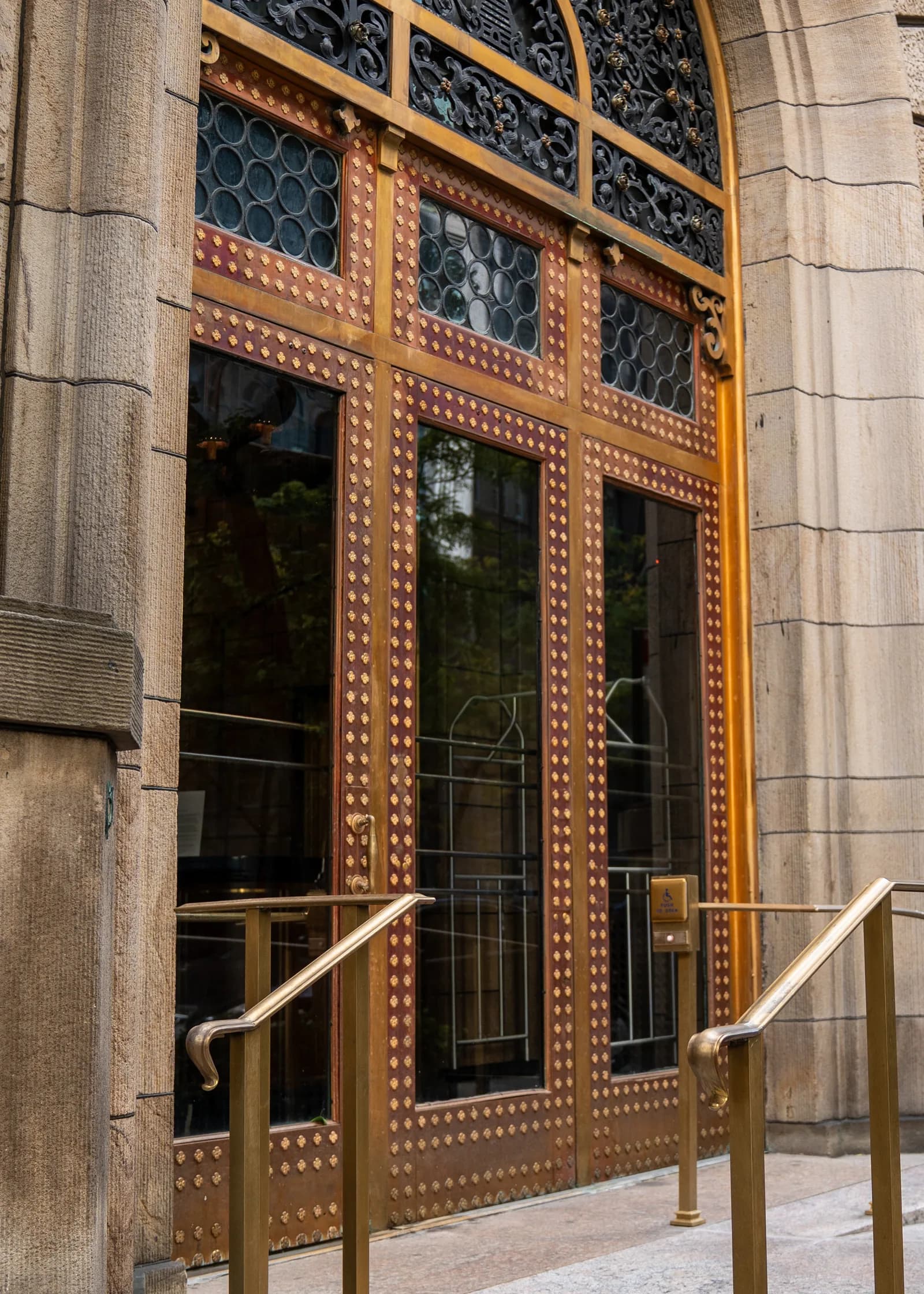 Detailed side view of the ornate doors and new entrance railings