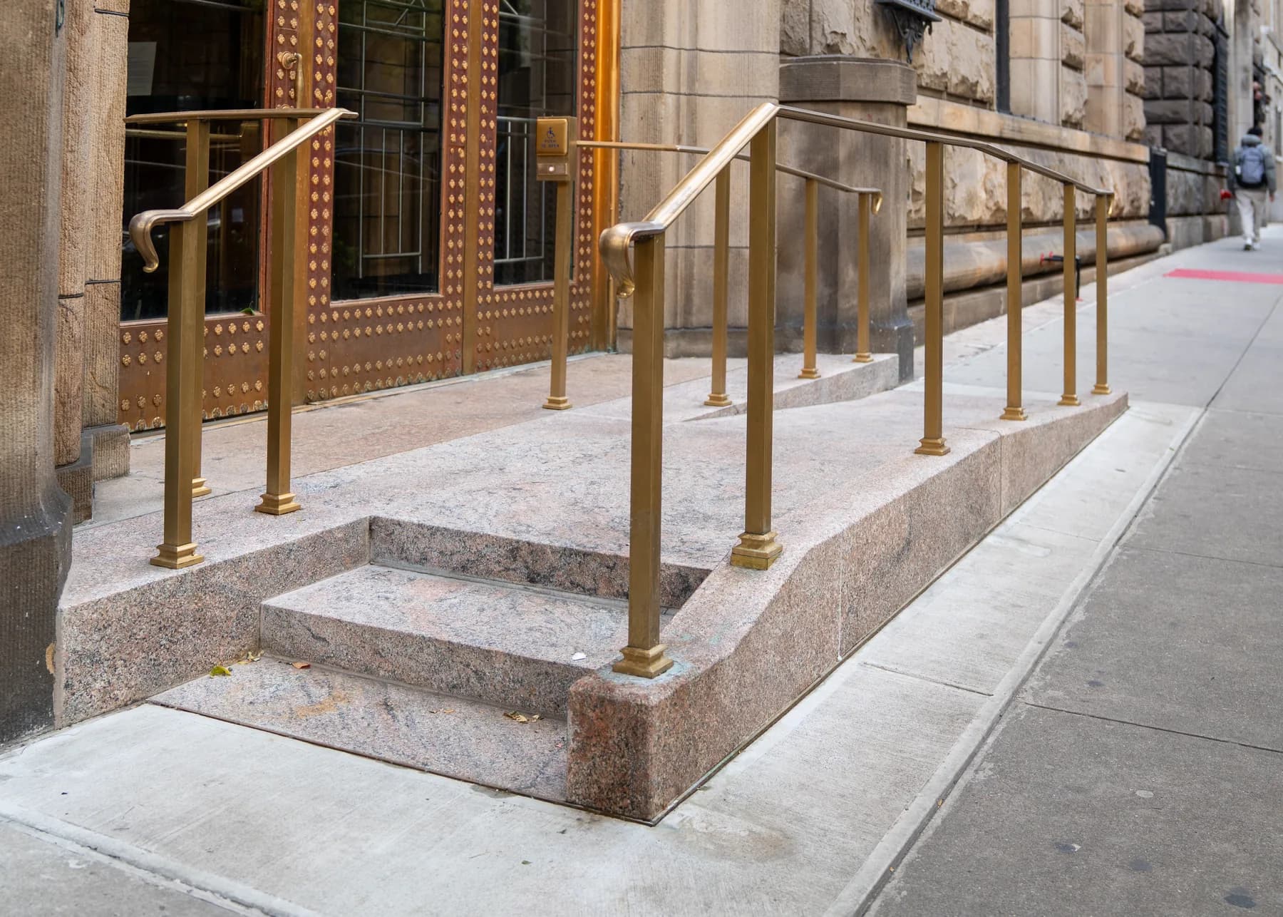 Accessible ramp platform and custom railings beside the historic doorway