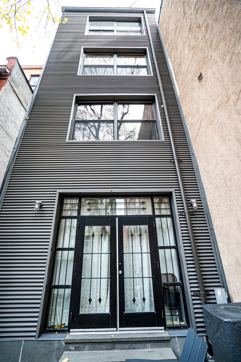 Corrugated-metal rear elevation with glazed entrance