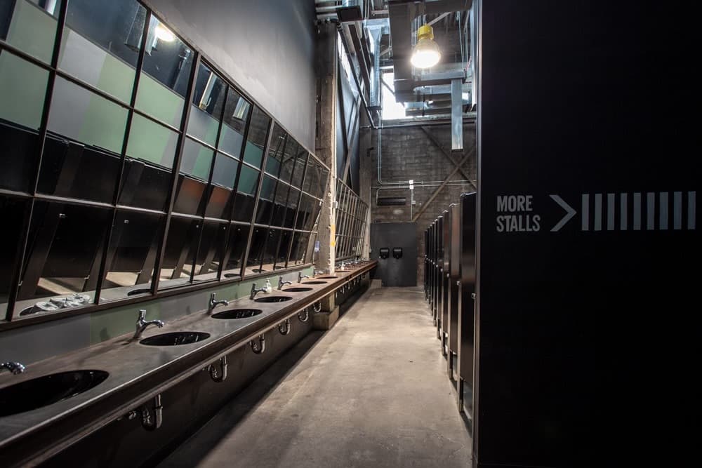 Venue restroom with custom mirrors and concrete counters