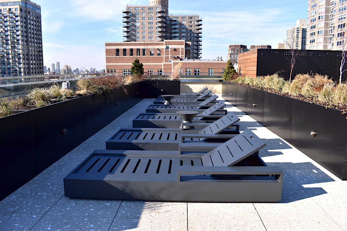 Rooftop lounge area with integrated planters and seating