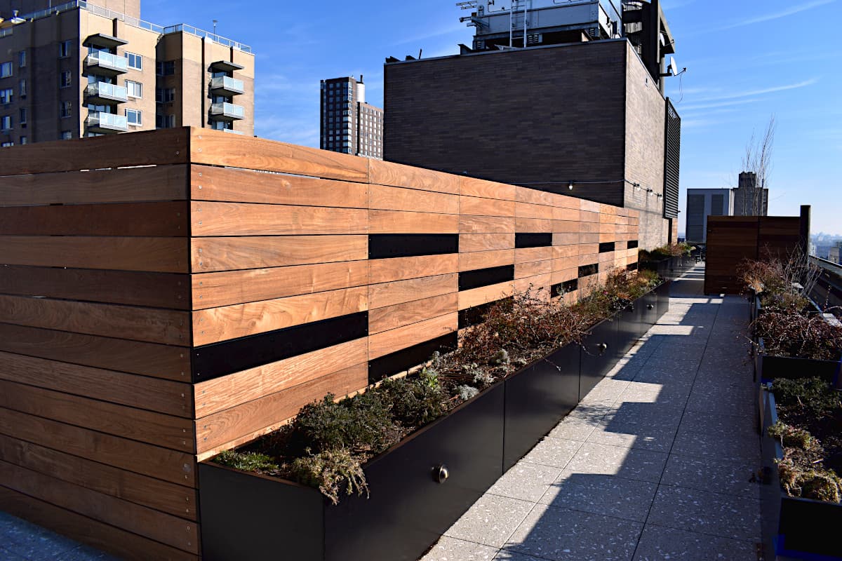 Custom Ipe enclosure integrated with metal planters