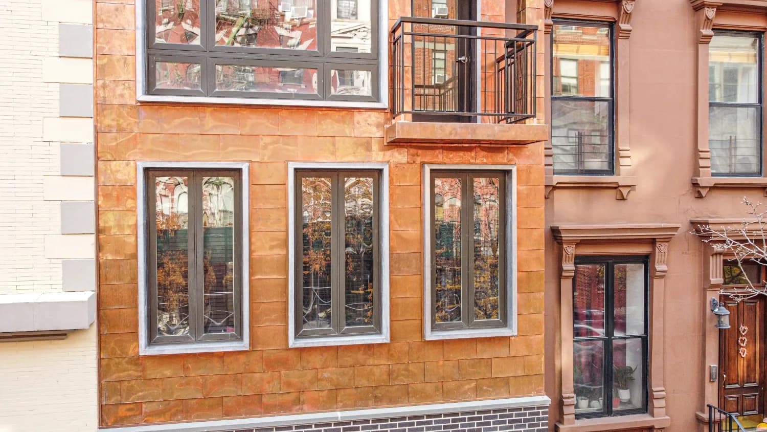 Copper panels, lower windows, and balcony metalwork