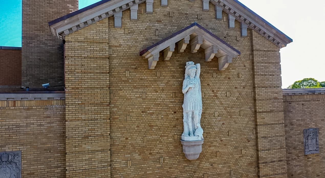 Restored brickwork, stone detailing, and devotional statue