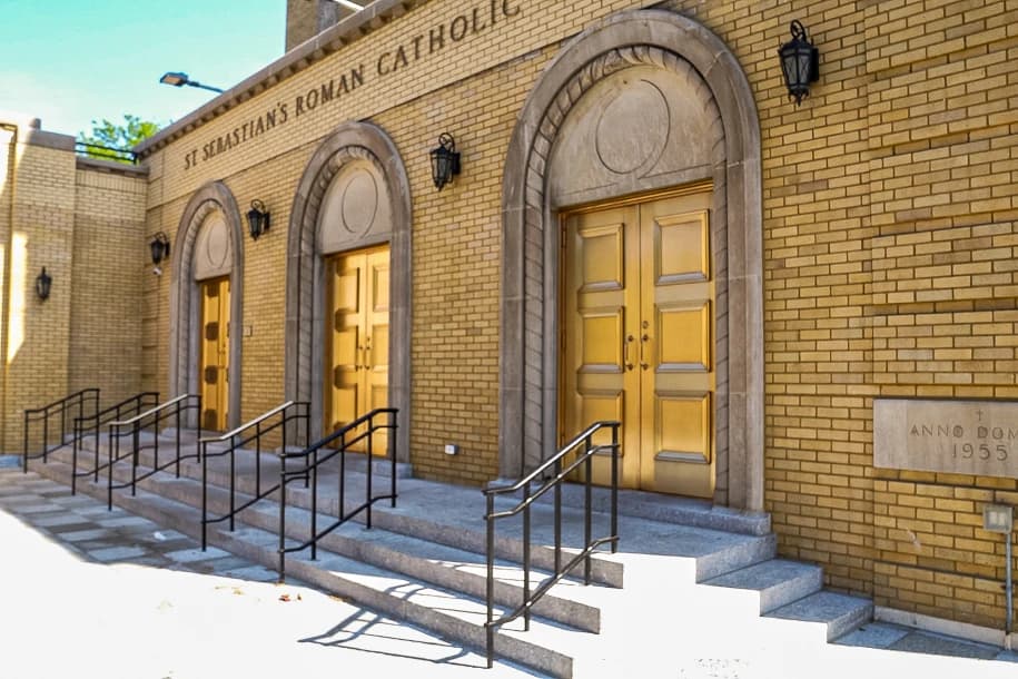 Three restored church entrances with new railings and steps