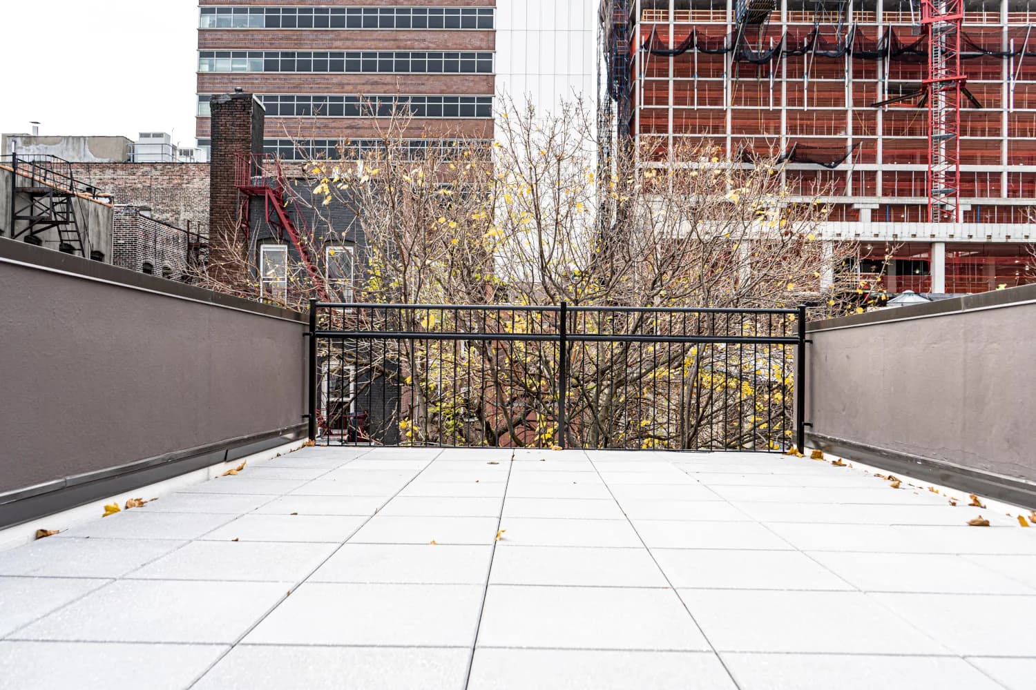 Completed roof terrace with pavers and metal railing