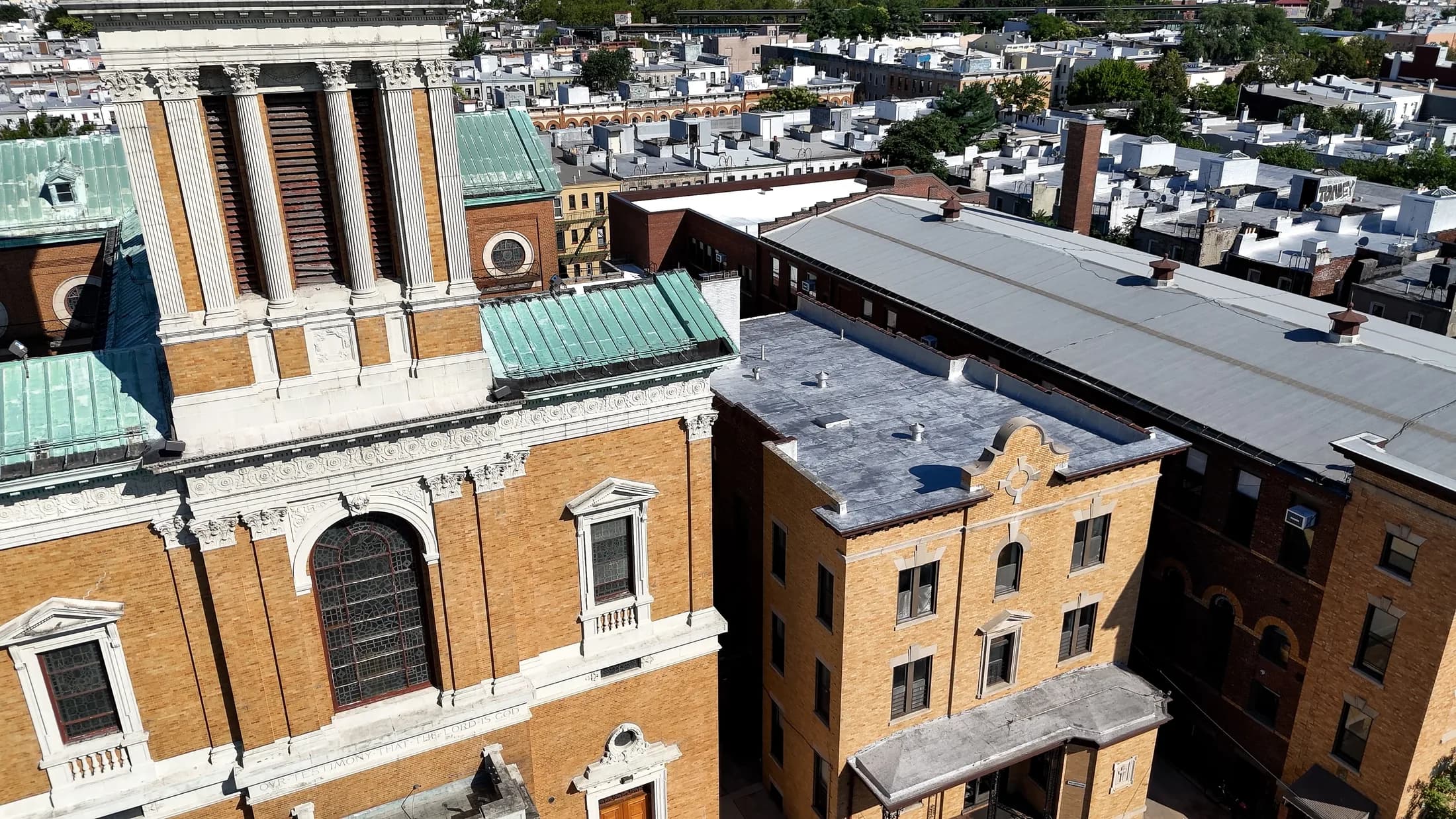 Aerial view connecting the St. Matthias church tower, parish buildings, and completed roof work