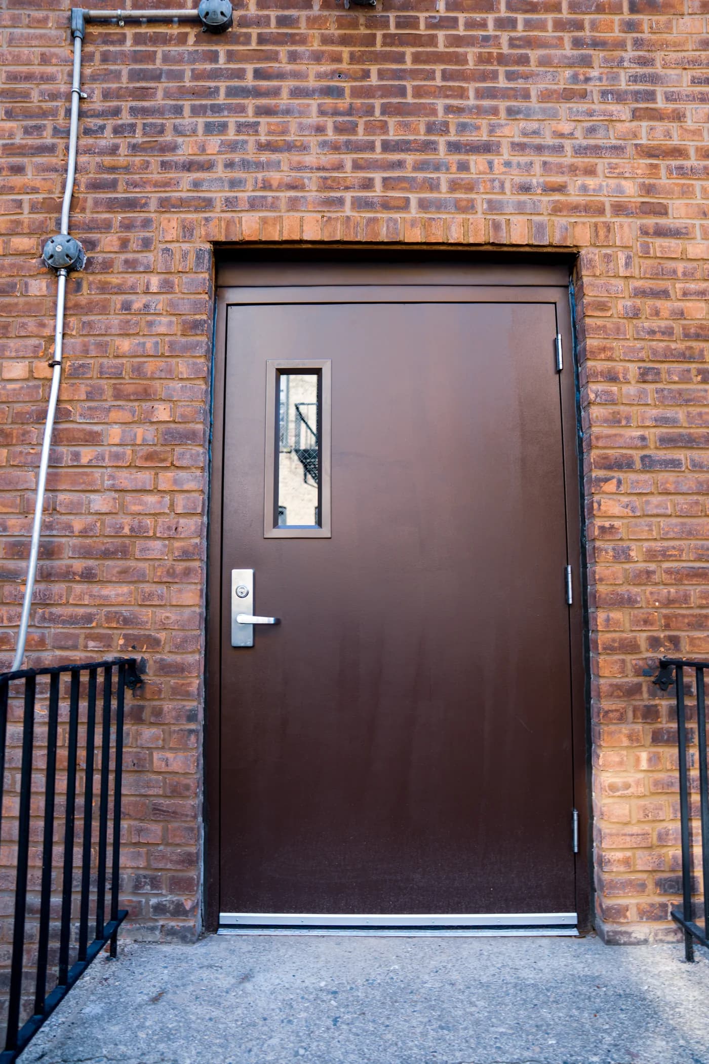 Restored exterior entrance door framed by brick masonry at St. Matthias RC Church