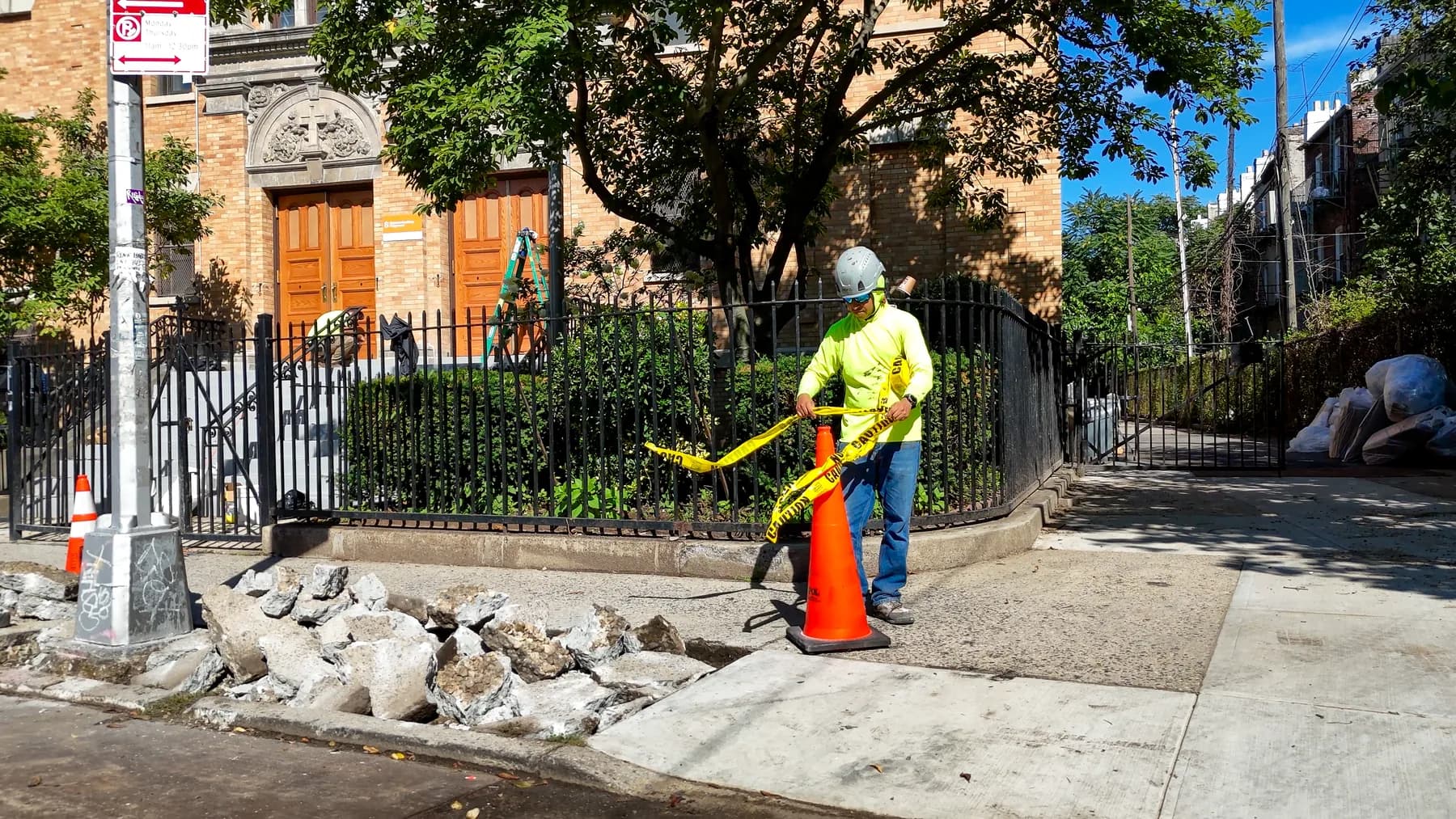 Jepol crew member working on the sidewalk outside St. Matthias RC Church