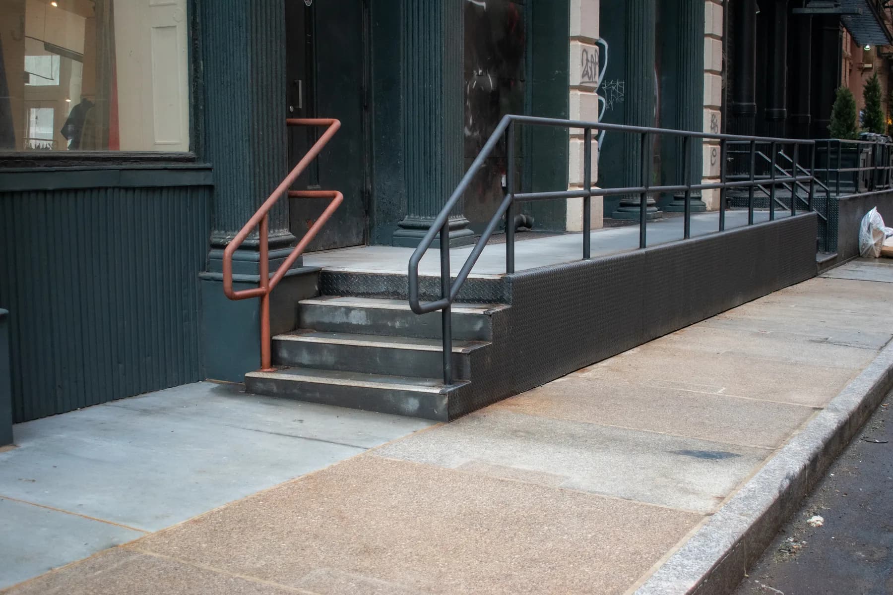 Finished entrance ramp and concrete sidewalk at 140 Broadway