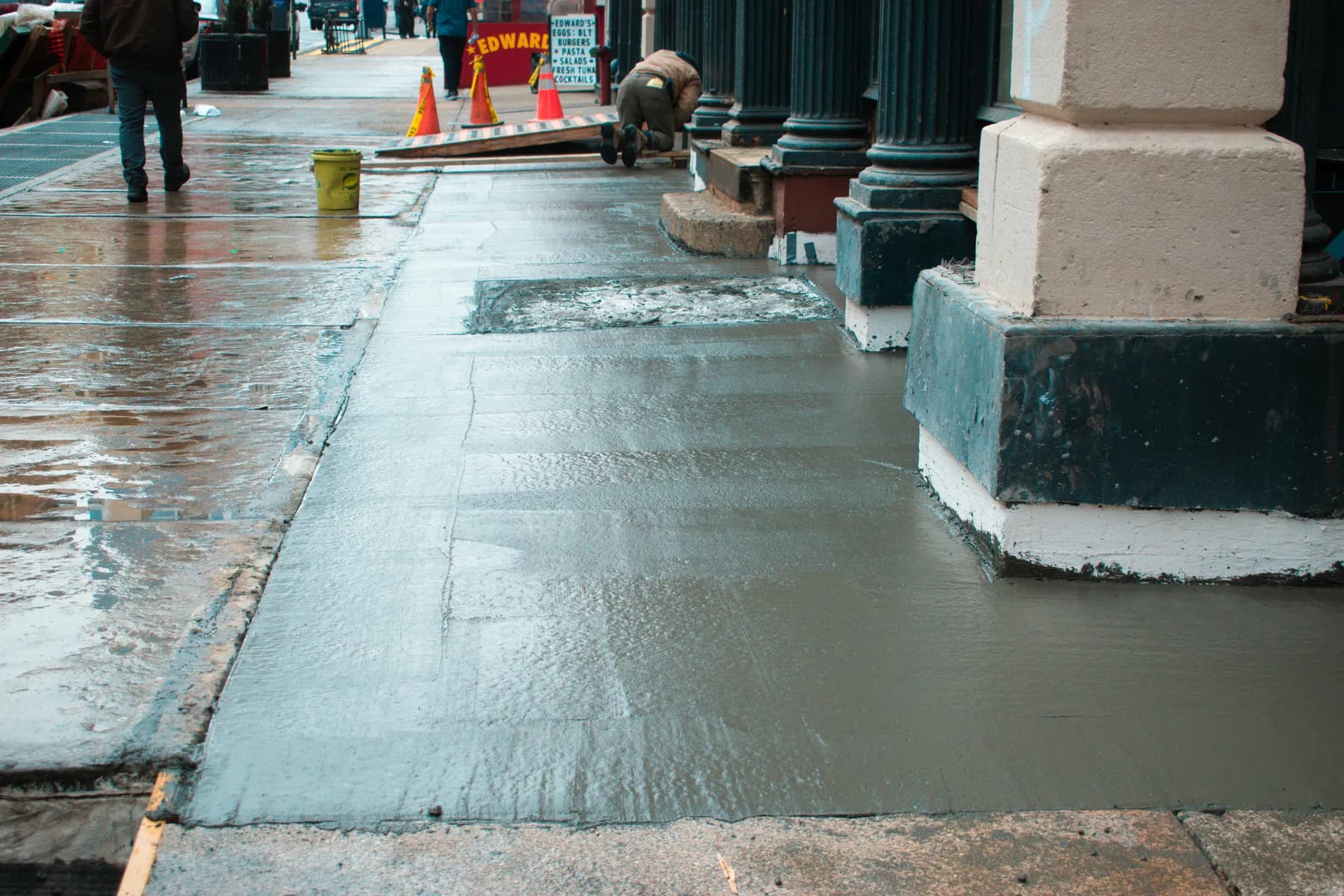 Freshly placed concrete sidewalk during work at 140 Broadway