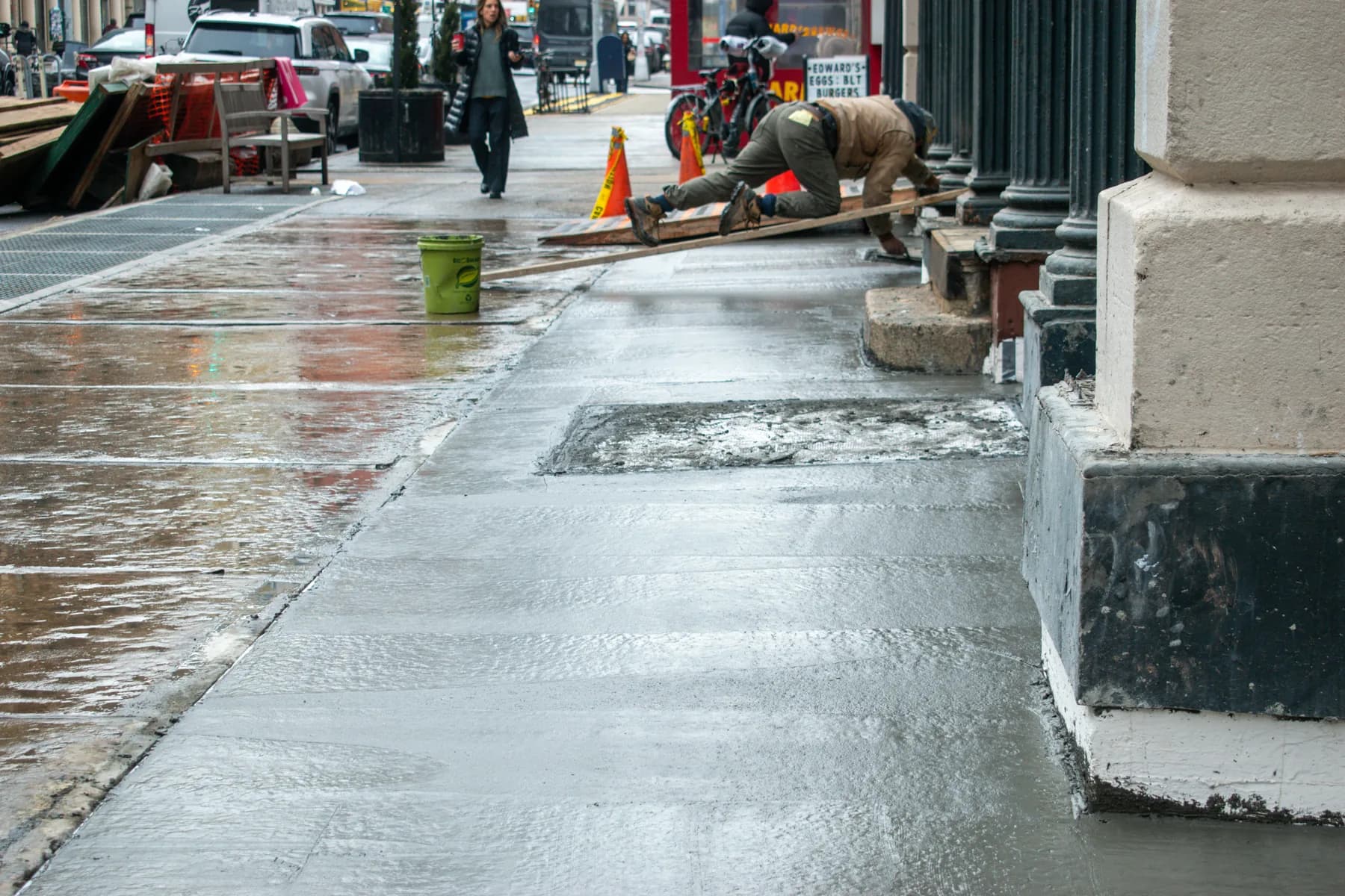 Jepol crew completing sidewalk work beside the 140 Broadway facade