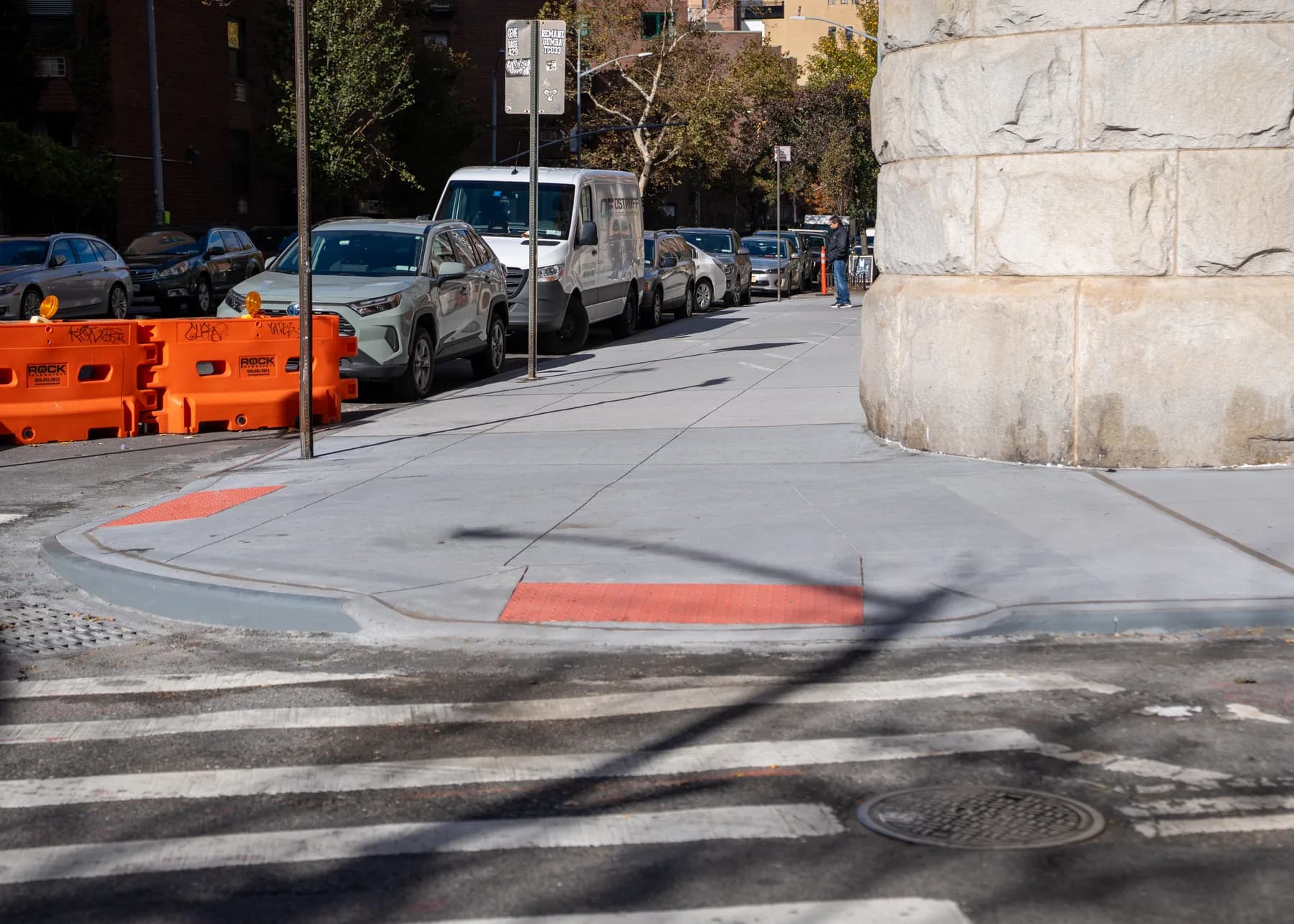 Accessible corner transition beside the masonry building