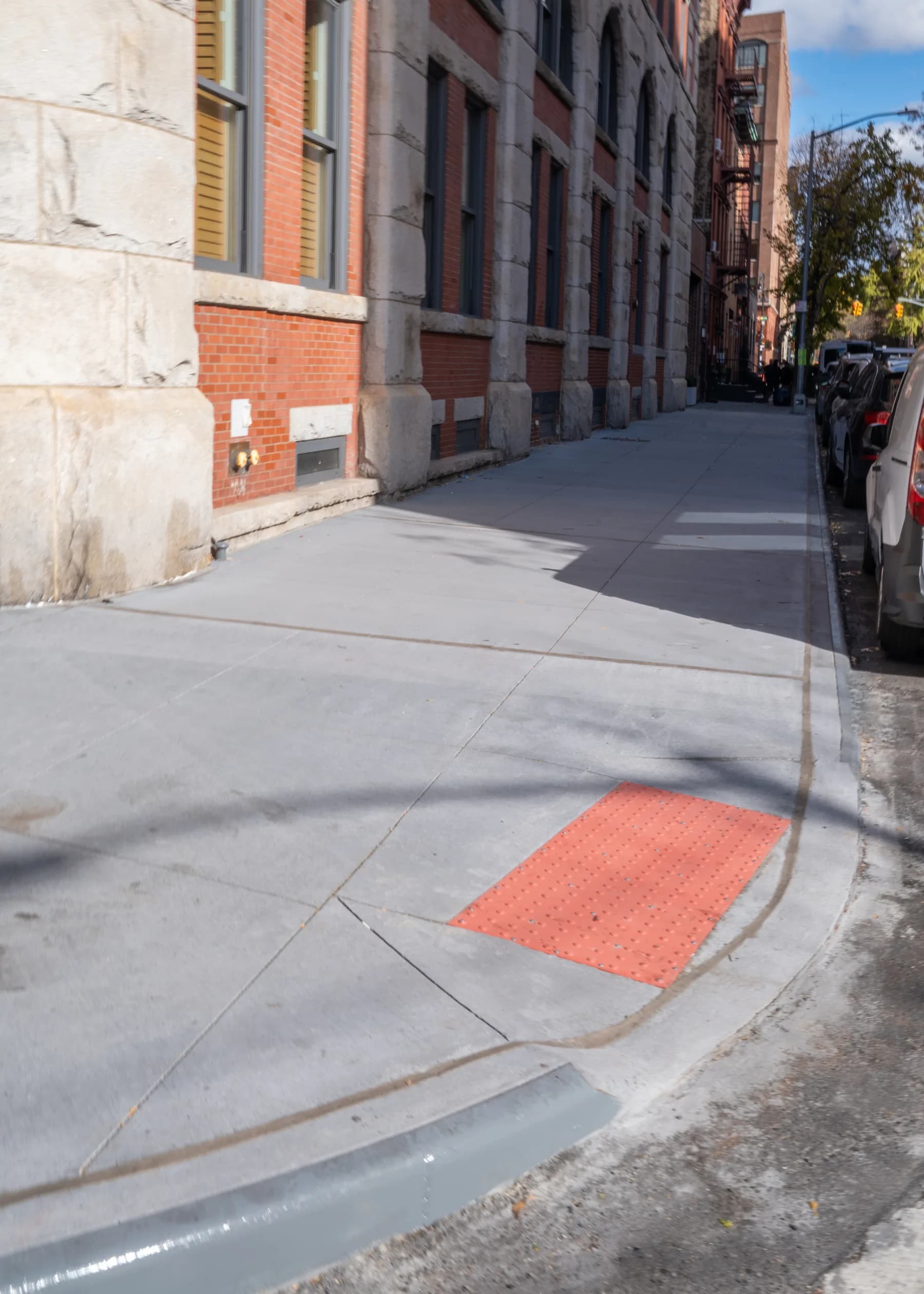Completed sidewalk corner viewed from the crosswalk approach