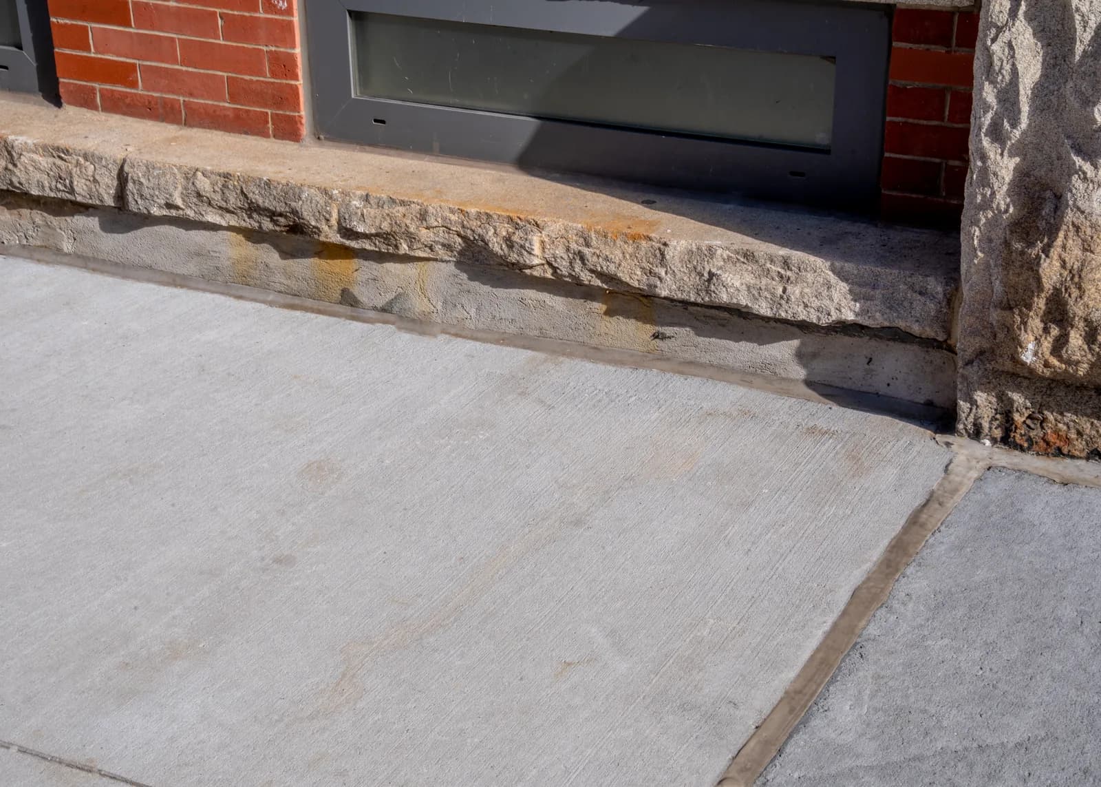Detailed transition between the new concrete and historic masonry base