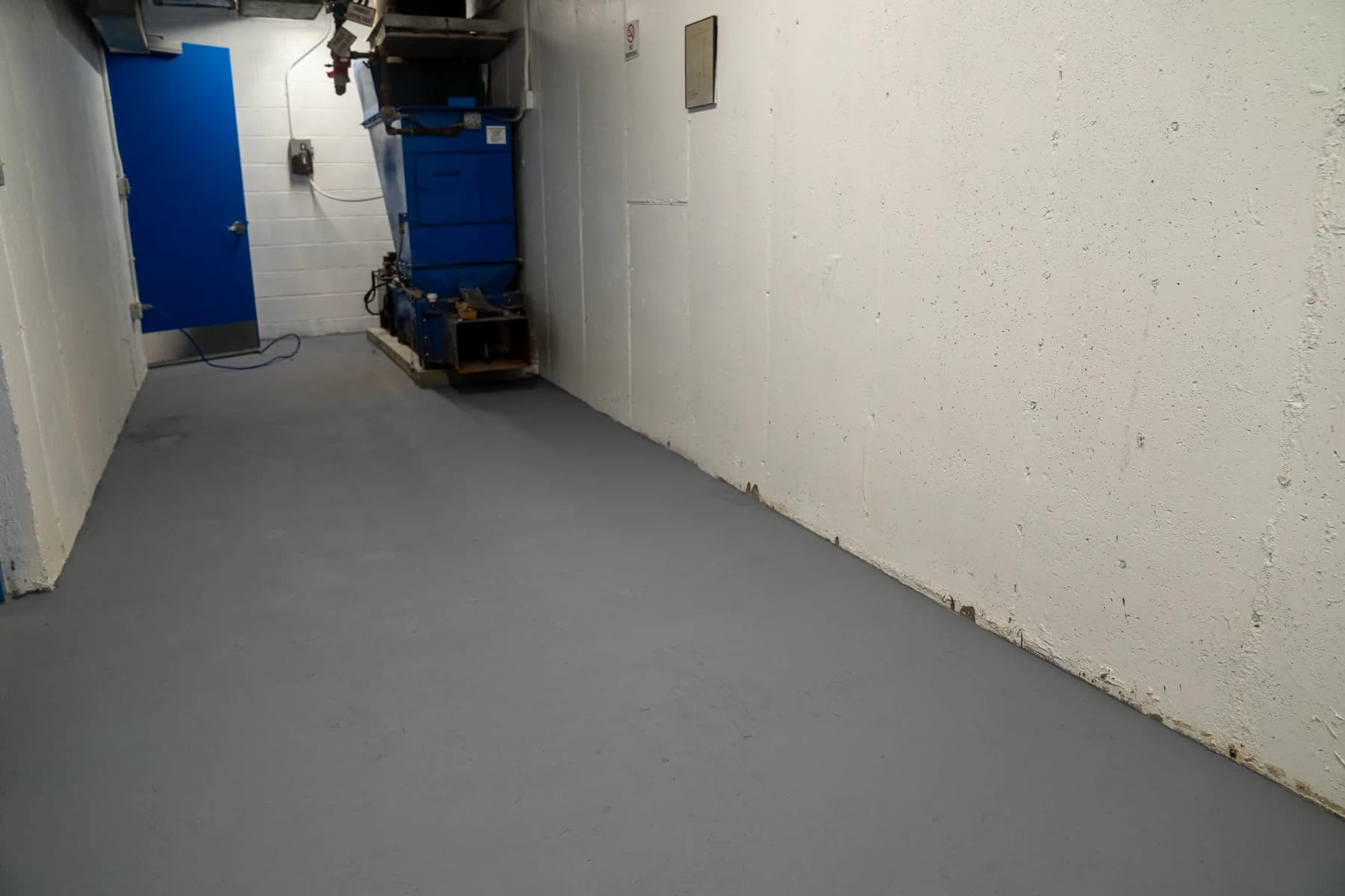 Completed mechanical room with durable floor finish and blue service doors