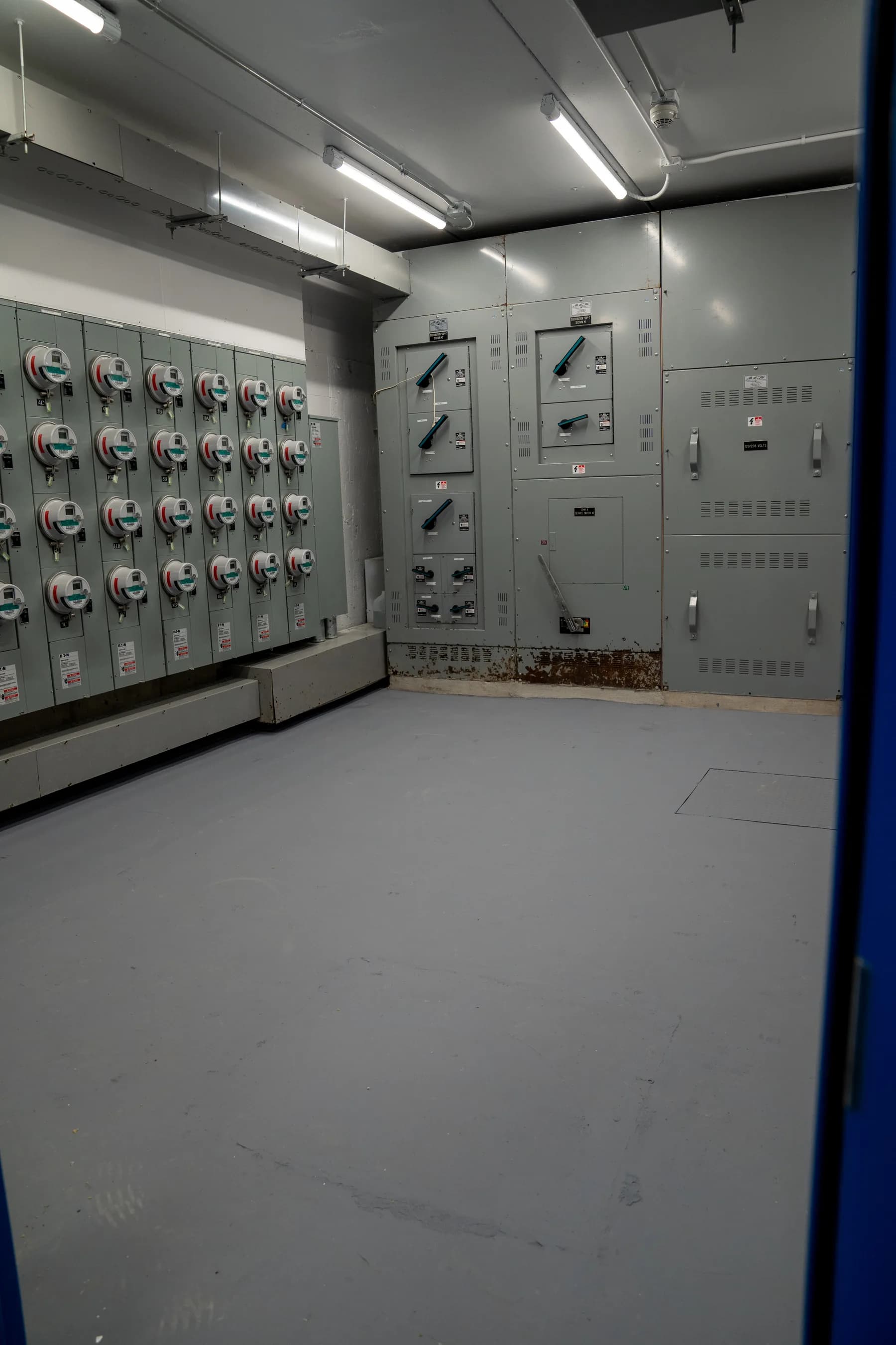Completed electrical room with new smooth gray floor at 6469 Broadway